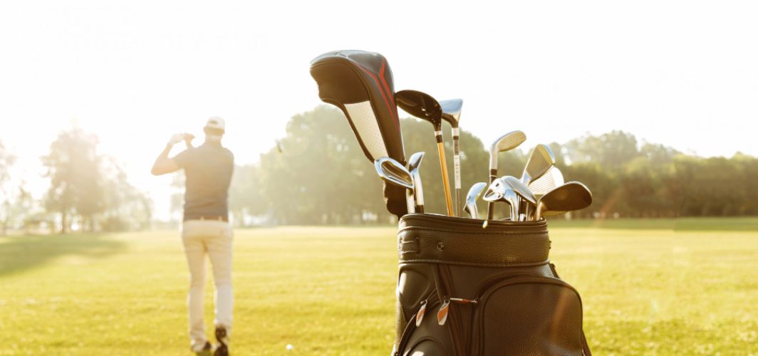 back-view-male-golfer-swinging-golf-club