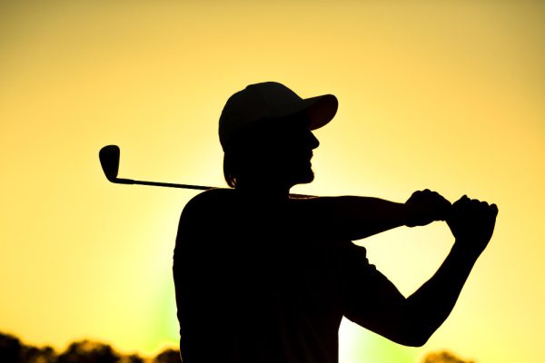 black-silhouette-closeup-male-golf-player-with-hat-teeingoff-beautiful-golf-course-professional-golf-player-smiling